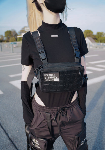 Dxrk Eternity patch attached to a bag , woren by a white women with blonde hair