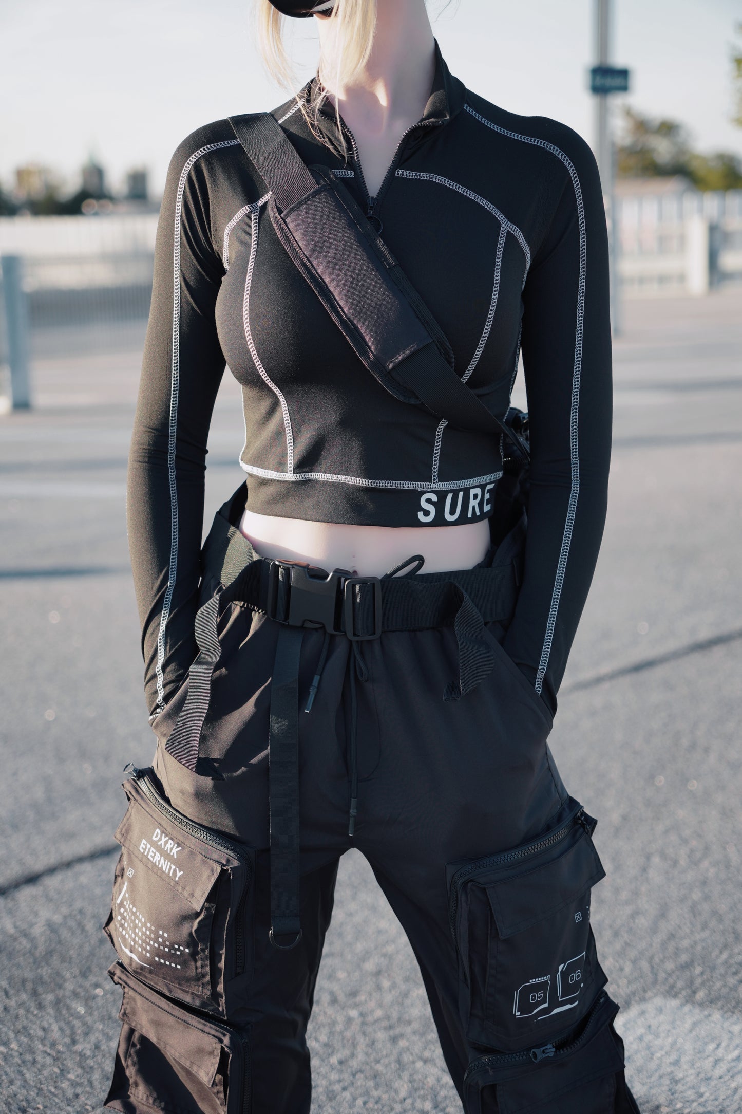 White women wearing Showcase of a techwear overhang bag