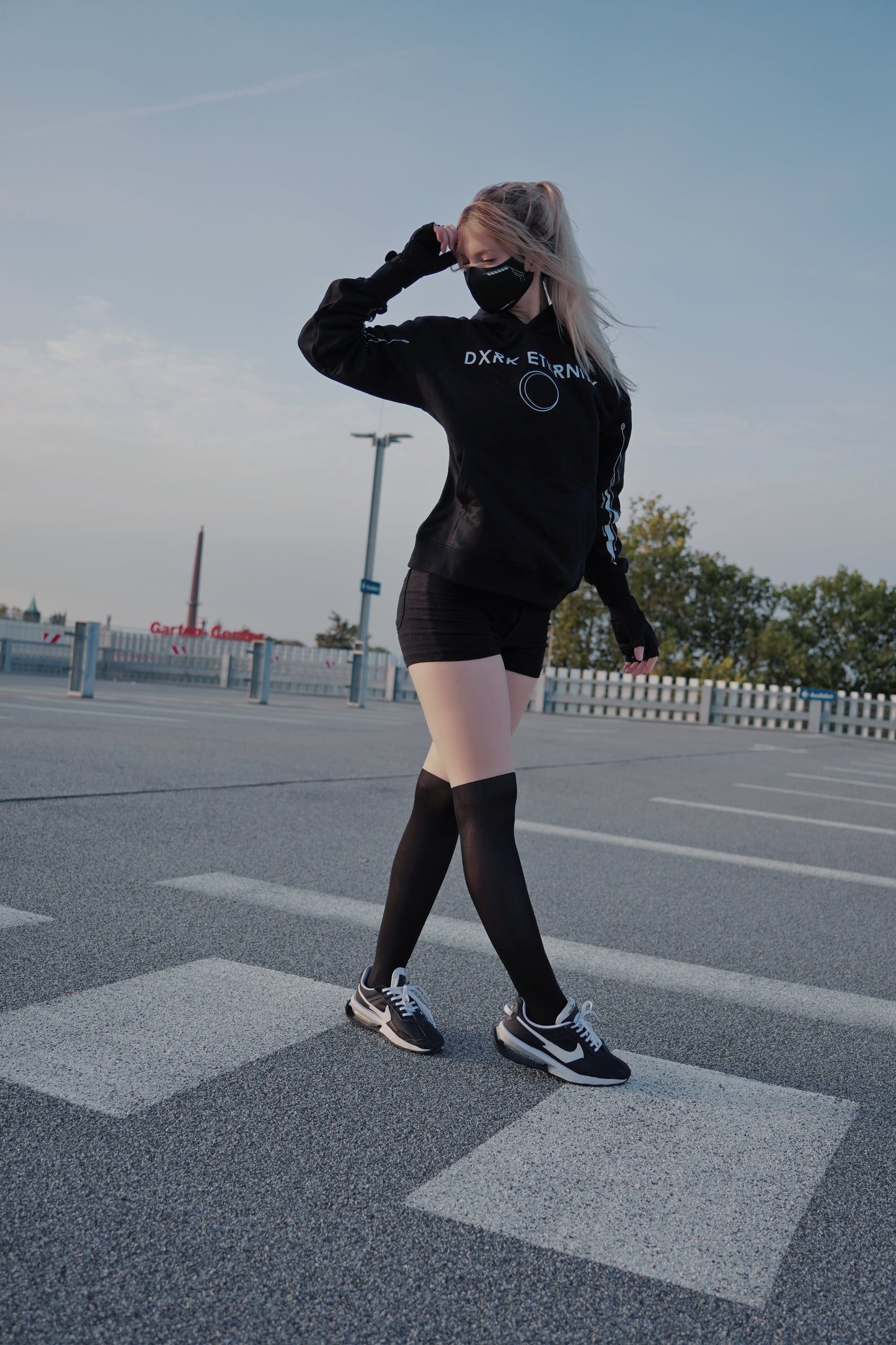 White women wearing 390gsm 100% Cotton Hoodie with Dxrk Eternity Logo printed